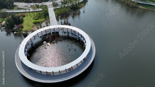 Bild auf Leinwand Aerial Close-Up of Circular Ring Walkway with Sunlit Water, Xiamen China