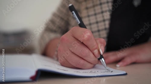 Woman Journaling Personal Thoughts in Notebook
