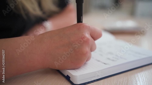 Woman Journaling Personal Thoughts in Notebook