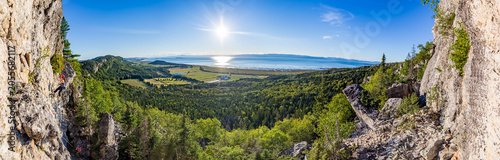 Rock Climber on Cliff with Panoramic View of St. Lawrence River, Kamouraska