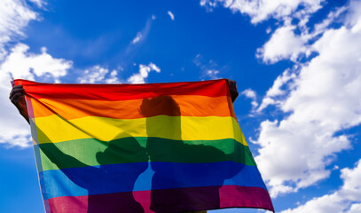couple holding rainbow flag for pride month