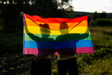 couple holding rainbow flag for pride month