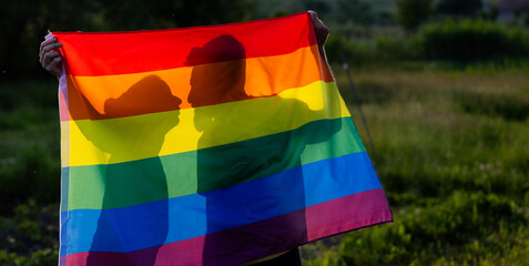 couple holding rainbow flag for pride month