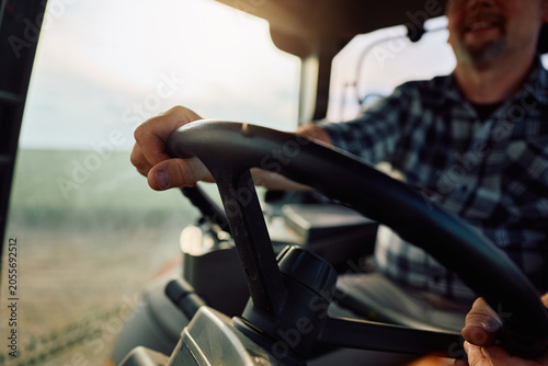 Εκτύπωση καμβά Close up of agricultural field worker cultivating land with tractor