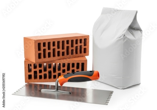 Bricks, a notched trowel and a bag of construction material isolated on white background