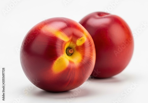 Two fresh ripe nectarines isolated on white background