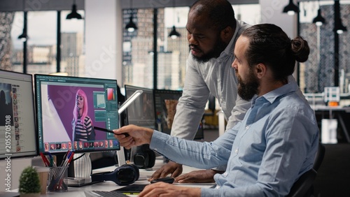 Фотография Diverse photographers working on image selection and retouching on editing software, color correction for commercial materials and catalog results, Post production agency in office studio