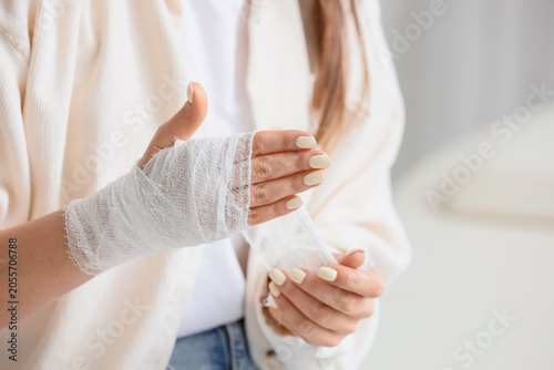 Womans injured hand wrapped...