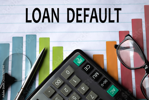 LOAN DEFAULT - words on a color chart with a calculator, magnifying glass and glasses
