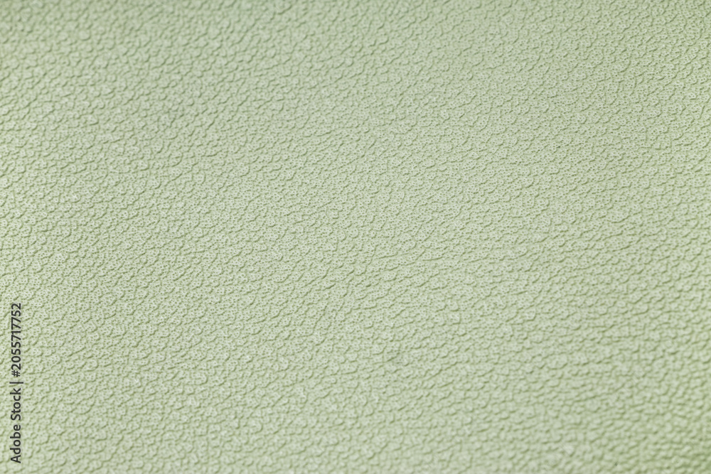 Fototapeta premium Light green textured surface background with subtle bumps and irregular pattern, abstract design element for graphic projects