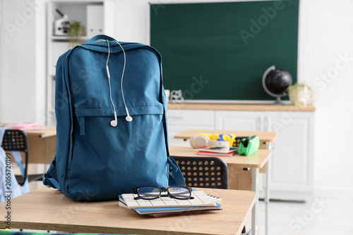Blue backpack with earbuds ...