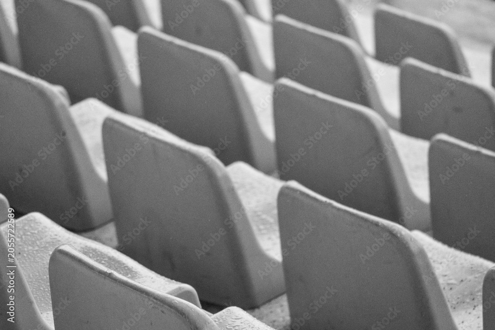 Fototapeta premium Black and White Empty Stadium Seats with Rain Drops in Sports Grandstand