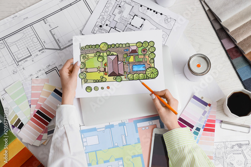 Принти на полотні Landscape architect designing residential garden plan with color palette and blu