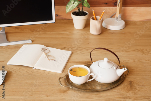 Home office desk with tea s...
