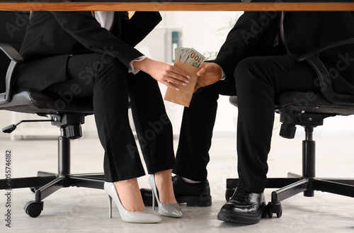 Obraz na plátne Business people exchanging money under table, bribery and corruption in corporat