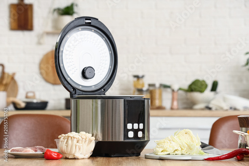 Canvastavla Modern electric rice cooker with open lid on kitchen countertop, fresh ingredien