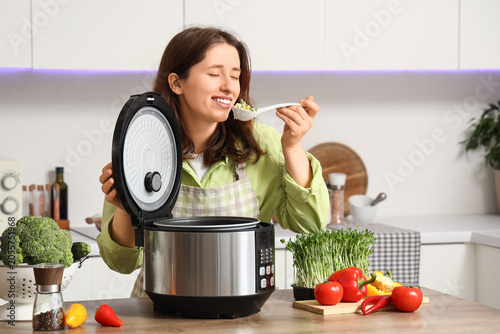Happy woman tasting freshly...