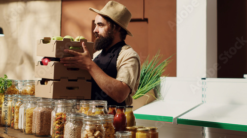 Obraz na plátně Owner bringing boxes of fresh produce, restocking his local neighborhood grocery shop with vegetables from his own garden