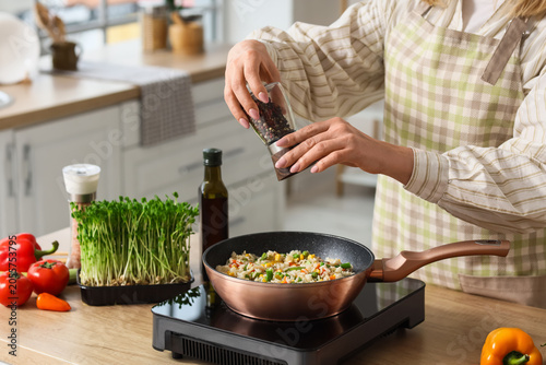Woman seasoning healthy veg...