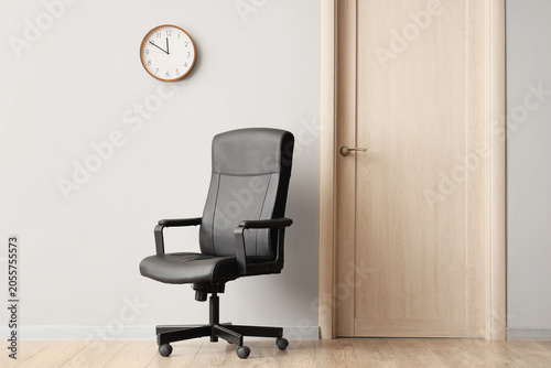 Empty office chair and wall...