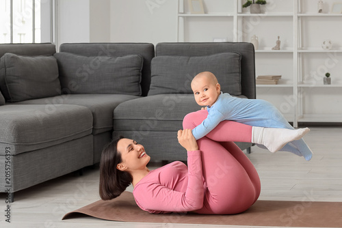 Happy mother and baby exerc...