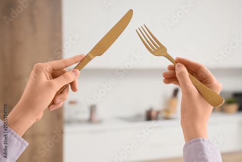 Golden knife and fork held ...