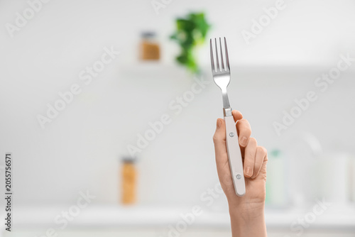 Hand holding silver fork wi...