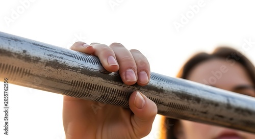 Closeup of a womans hand gripping a textured metal bar during an outdoor workout, strength and fitness concept