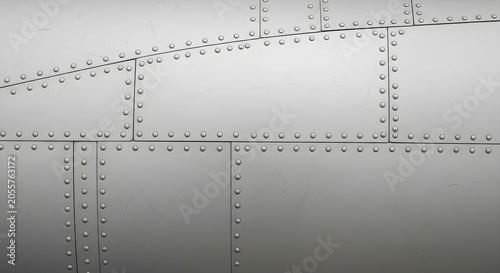 Close-up of riveted metal panels, industrial texture background