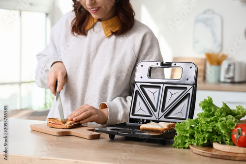 Young woman cutting freshly...