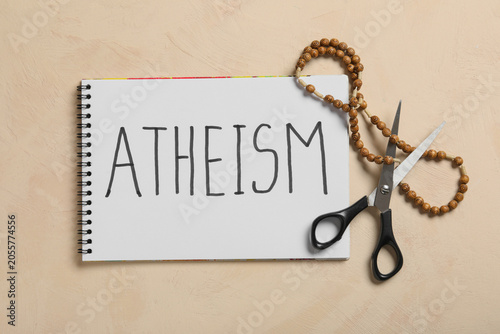 Bild auf Leinwand Atheism with notebook, scissors, and rosary beads on textured background, religi