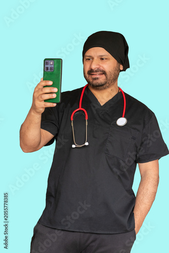 Friendly male doctor smiling while having a video call on smartphone