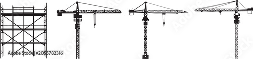Four construction tower cranes lifting materials at a building site
