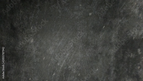 A moody, dark charcoal-colored surface with a matte finish. The texture looks like natural slate or stone, providing an elegant and sophisticated dark background. 