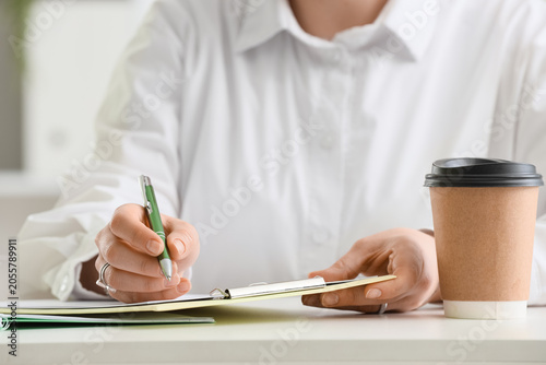 Businesswoman writing notes...