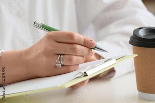 Professional woman writing ...
