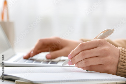 Student hands writing notes...