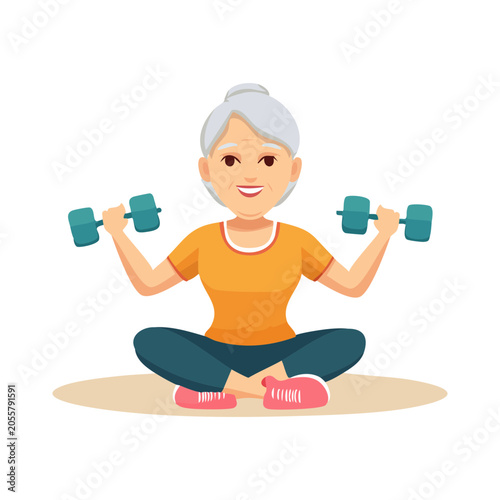 Active Senior Woman Exercising with Dumbbells While Sitting Cross Legged on Fitness Mat.