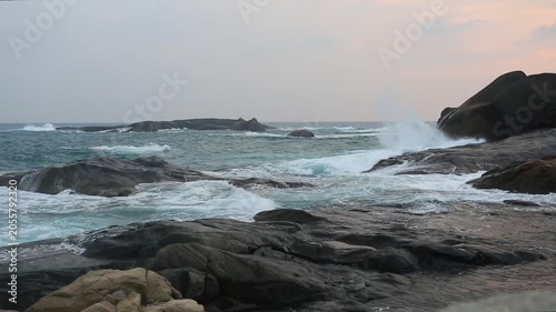 Huge waves crashing against the rocks。Stone Park Scenic Area, Hainan, China