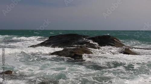 Huge waves crashing against the rocks。Stone Park Scenic Area, Hainan, China