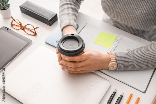 Young woman with cup of cof...