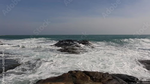 Huge waves crashing against the rocks。Stone Park Scenic Area, Hainan, China