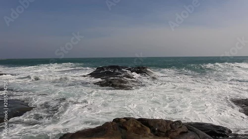 Huge waves crashing against the rocks。Stone Park Scenic Area, Hainan, China