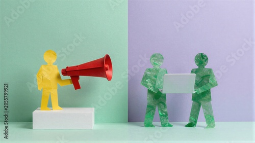 Paper cutouts show one person shouting with a megaphone, while two others use laptops.