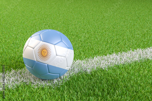 Bilde på lerret Football / soccer ball with a flag overlay of Argentina on a football pitch background