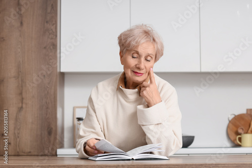Beautiful senior woman read...