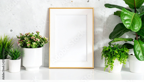 Blank Picture Frame Surrounded by Houseplants: A minimalist composition featuring an empty picture frame with a golden border, beautifully arranged with various potted green houseplants on a shelf.