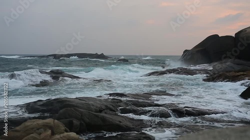 Huge waves crashing against the rocks。Stone Park Scenic Area, Hainan, China