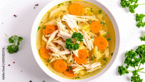 Heartwarming Chicken Noodle Soup: A delicious bowl of homemade chicken noodle soup, featuring tender shredded chicken, vibrant carrot slices, and fresh parsley garnish.