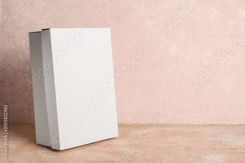 White shoebox on beige grun...